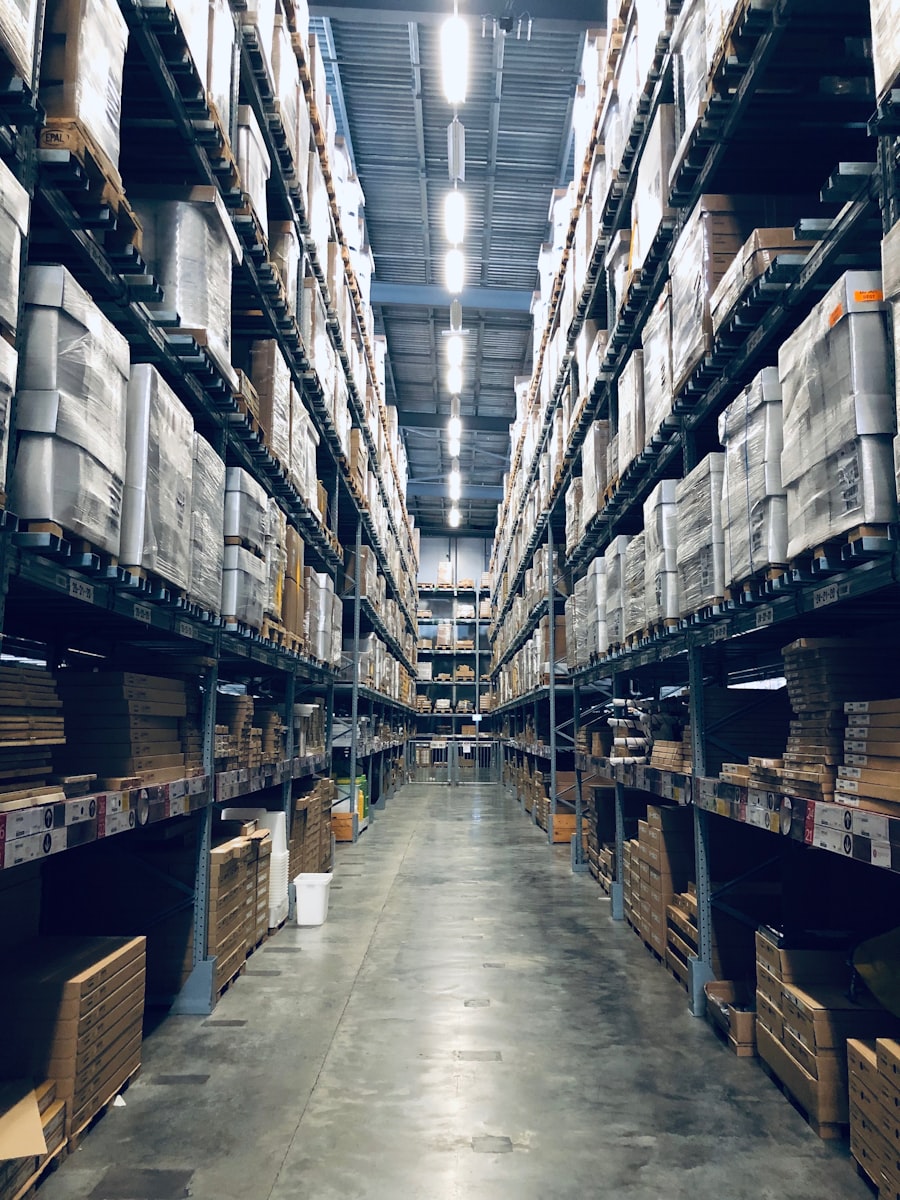 Warehouse aisle between tall racks of boxed inventory